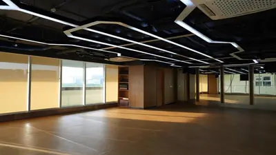 a large room with a wooden floor in a building at Coastal Luxury Residences in Manila