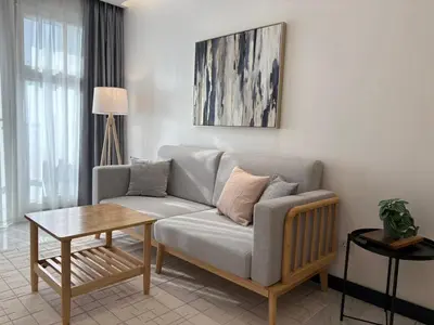 a living room with a couch and a table at Coastal Luxury Residences in Manila