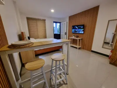 a kitchen with two stools and a counter top at Flat 35, Unit E in Manila