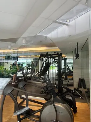 a gym with treadmills and ellipticals in a building at Cami Haus at Fame Residences in Manila