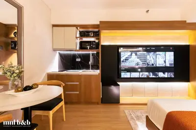 a living room with a large television in a room at Near Venice Mall! Hotel 1BR Unit in Viceroy Residences in Manila