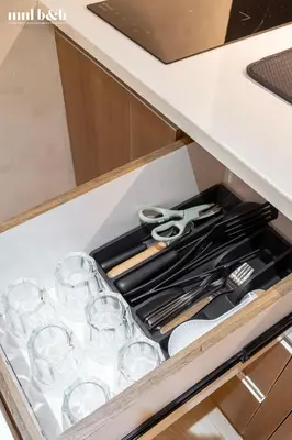 a drawer filled with wine glasses and scissors at Near Venice Mall! Hotel 1BR Unit in Viceroy Residences in Manila