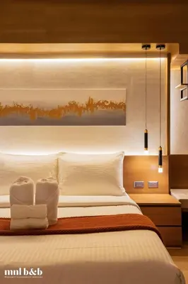 a bedroom with a large bed with white sheets and pillows at Near Venice Mall! Hotel 1BR Unit in Viceroy Residences in Manila