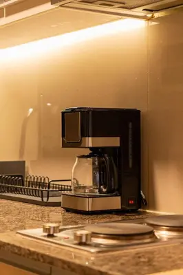 a microwave sitting on top of a kitchen counter at Amazing View - Cozy 1BR at One Eastwood with Washer High Speed Wi-Fi in Manila