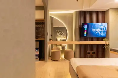 a bedroom with a bed and a tv on a wall at Amazing View - Cozy 1BR at One Eastwood with Washer High Speed Wi-Fi in Manila