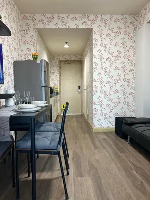 a kitchen with a table and chairs and pink wallpaper at Family Condo SMB in Manila