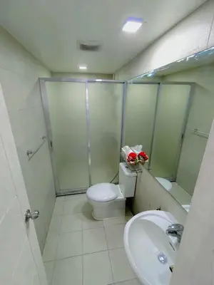 a bathroom with a shower and a toilet and a sink at Azure Staycation by Casa Tremora Deluxe in Manila