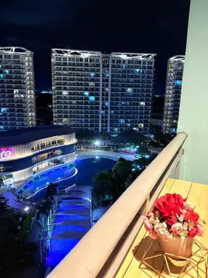 a view of a building with a pool at night at Azure Staycation by Casa Tremora Deluxe in Manila
