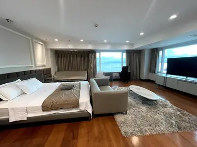 a bedroom with a bed and a couch and a television at Ultra Luxury 5BR Penthouse in Manila Bay Rizal Park in Manila