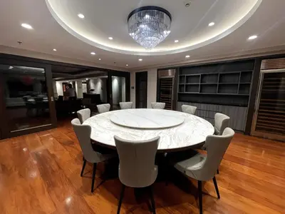 a dining room with a large white table and chairs at Ultra Luxury 5BR Penthouse in Manila Bay Rizal Park in Manila