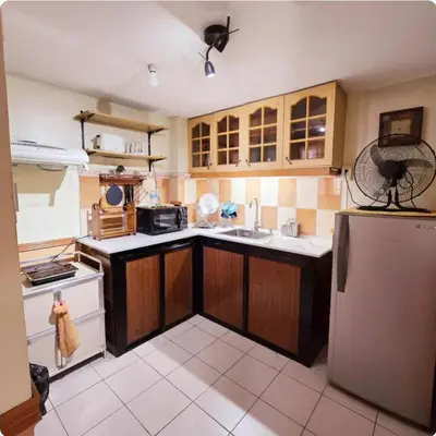 a kitchen with a sink and a refrigerator at Greenhills Garden Square Residences 2BR & 2 Toilets Quezon City in Manila