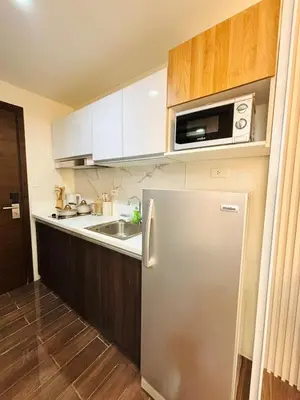 a kitchen with a stainless steel refrigerator and a microwave at Luxurious Room in Bel Air Makati - Air Residences in Manila
