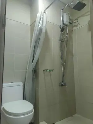 a bathroom with a toilet and a shower at Marhulz Two Bedroom Staycation at S Residences in Manila