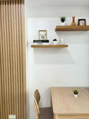 a dining room with a wooden table and a chair at Premium Unit in Maldives in Manila