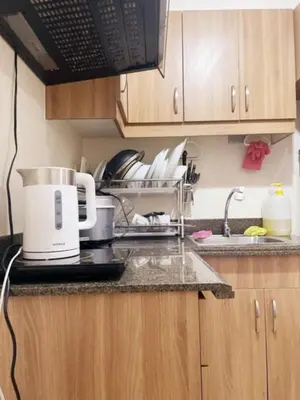 a kitchen counter with a sink and a coffee pot on it at Torre de Manila Taft Avenue near Luneta Park US Embassy Intramuros Ermita Manila in Manila