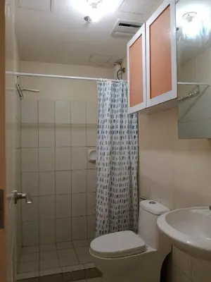 a bathroom with a toilet and a sink at Torre de Manila Taft Avenue near Luneta Park US Embassy Intramuros Ermita Manila in Manila