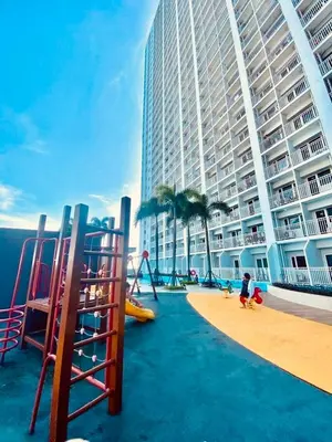 a playground in front of a large building at Smdc Breeze Residences-The Metro Breeze-Staycation in Manila