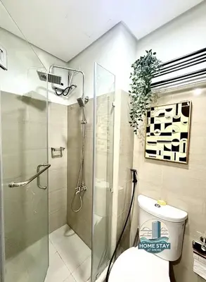 a bathroom with a toilet and a glass shower at SHORE 2 Residences MALL OF ASIA, NAIA, PICC in Manila