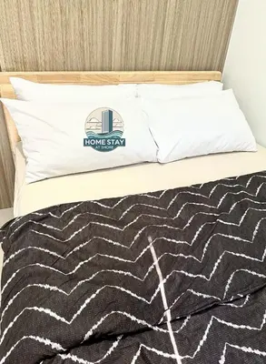 a bed with a home stay pillow on it at SHORE 2 Residences MALL OF ASIA, NAIA, PICC in Manila
