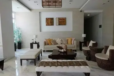 a living room with a couch and a table at Staycation in Brgy Buli in Manila