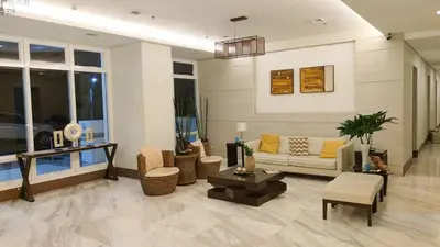 a living room with a couch and a table at Staycation in Brgy Buli in Manila