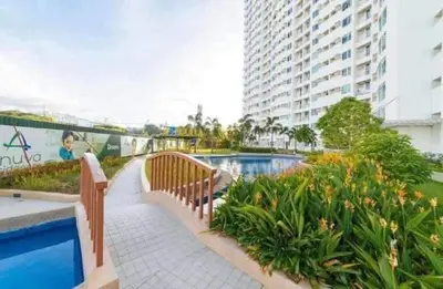 a resort with a swimming pool and a building at Staycation in Brgy Buli in Manila