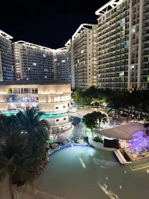 a large pool of water in front of a large building at Condotels RQ Hob in Manila