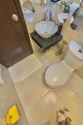 a bathroom with a toilet and a sink at 1 Br - Royalty Vacation - Edsa Makati in Manila