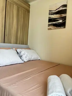 two beds sitting next to each other in a room at Fame Residence Tower 4 near Greenfield and Shaw MRT in Sampong