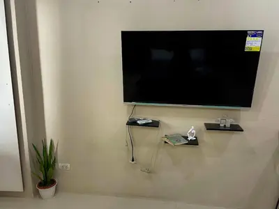 a flat screen tv hanging on a wall at XYz's Condo - Walk To MNL T3 via Runway Manila in Manila