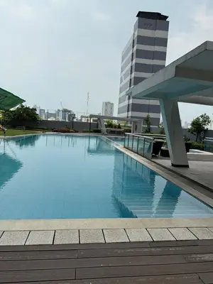 a large swimming pool in front of a building at Staycation and WFH with Netflix and Pool for up to 4 guests in Manila