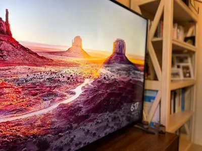 a flat screen tv sitting on top of a wooden shelf at Staycation and WFH with Netflix and Pool for up to 4 guests in Manila