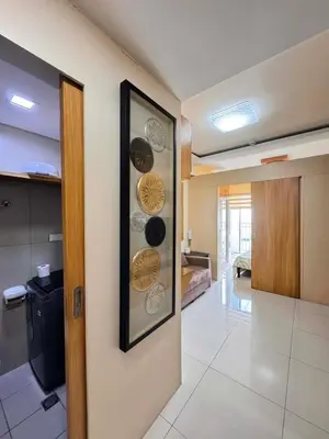 a room with a kitchen with plates on the wall at Kitty Breeze Staycation in Manila