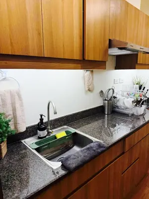 a kitchen counter with a sink in a kitchen at The Camden Place Aesthetic Elegant Condo Unit 15 in Manila
