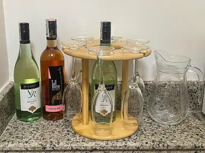 a group of wine bottles and glasses on a counter at La Mari Staycation 2bedroom at Prisma Residences in Manila