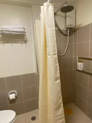 a shower curtain in a bathroom with a toilet at La Mari Staycation 2bedroom at Prisma Residences in Manila