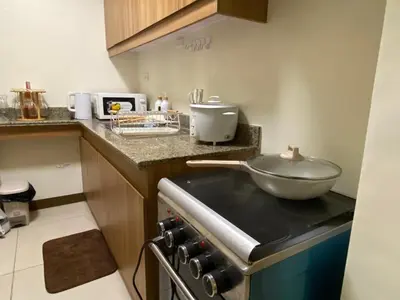 a kitchen with a bowl on top of a stove at La Mari Staycation 2bedroom at Prisma Residences in Manila