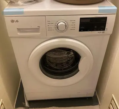 a white washing machine sitting in a room at La Mari Staycation 2bedroom at Prisma Residences in Manila