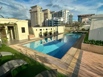 a swimming pool with a city skyline in the background at Jazzy Flat in Manila