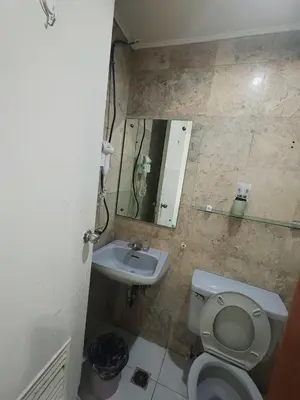 a small bathroom with a toilet and a sink at Ancalm condon in Manila