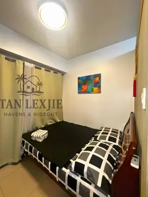 a bedroom with a bed with a black and white at Tan LexJie Havens and Hideout in Manila