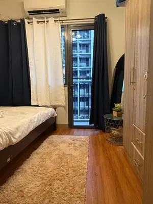 a bedroom with a bed and a window at S&B rentals in Manila