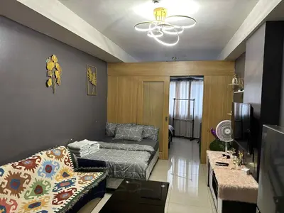a living room with a couch and a bed in it at Shell residence Family room by Kathy in Manila