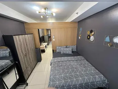 a room with two twin beds and a hallway at Shell residence Family room by Kathy in Manila