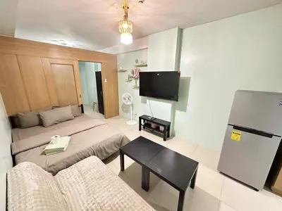 a living room with a couch and a tv in it at Shell residence Family room by Kathy in Manila