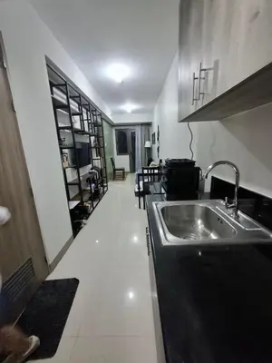 a kitchen with a sink and a counter top at S Residences MOA by darpm in Manila