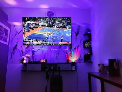 a living room with a tv on a purple wall at Shore 2 in Manila