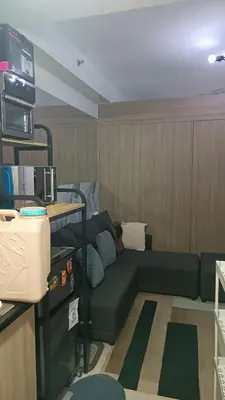 a living room with a green couch in a room at Shore 2 in Manila