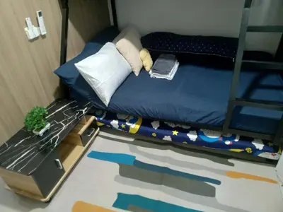 a small bedroom with a bunk bed with a table at Shore 2 in Manila