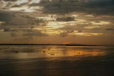a sunset over a body of water with clouds at Elegant 3 Bedroom unit with Ocean View near Okada in Manila